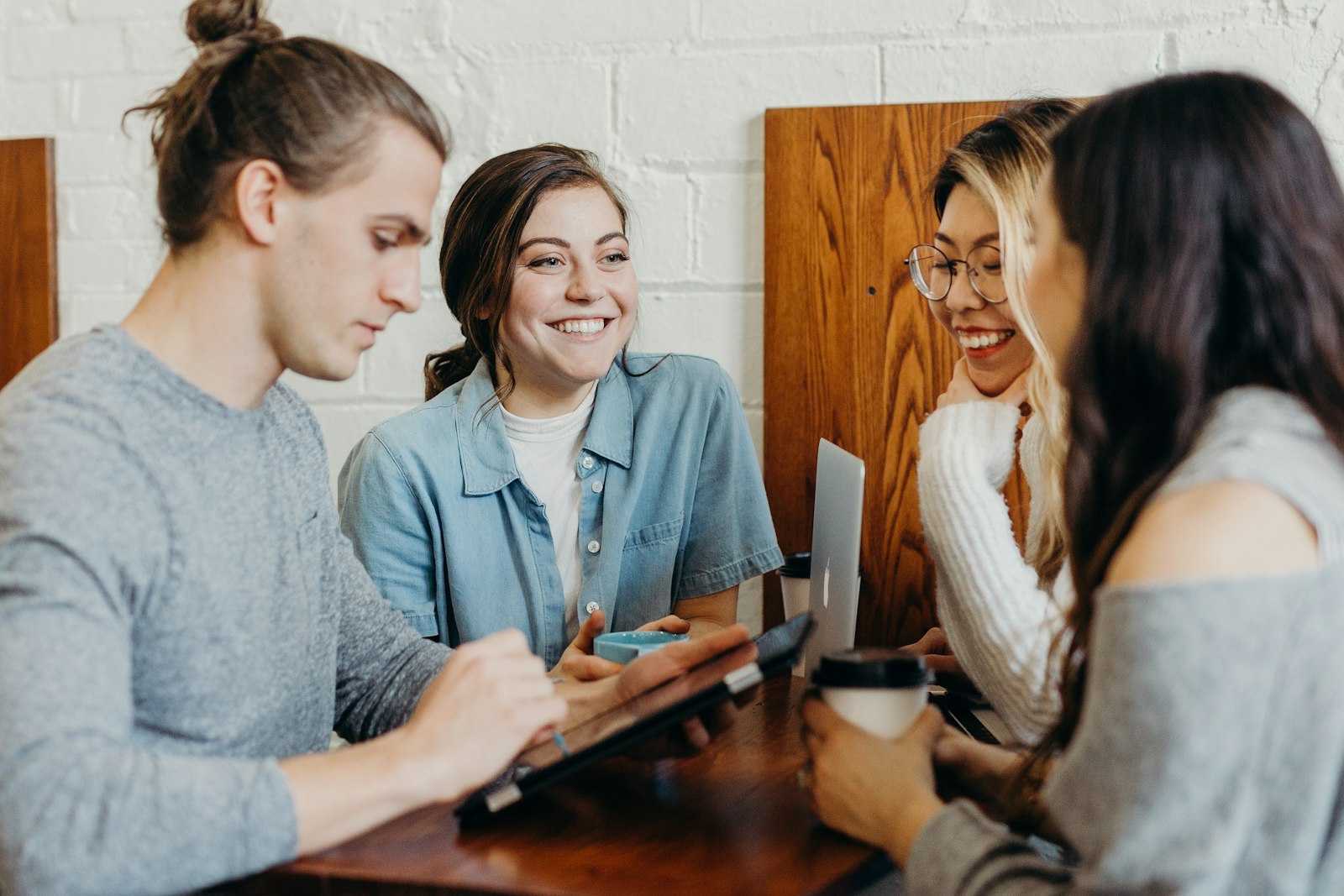 A small leadership team in genuine conversation around a table